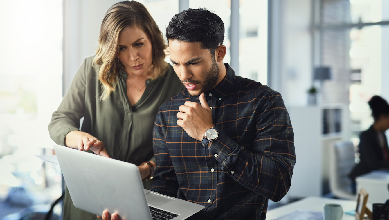 Shot of two businesspeople working together on a laptop in an office